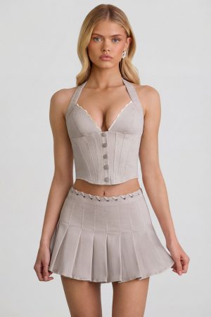 Low-Rise Pleated Mini Skirt in Ecru